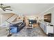 Spacious living room with modern decor, open floor plan, and staircase at 156 117Th Ave, Treasure Island, FL 33706