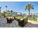Waterfront patio with lounge furniture and boat dock for relaxing and entertaining by the canal at 156 117Th Ave, Treasure Island, FL 33706
