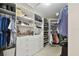 Organized walk-in closet with custom shelving provides ample storage and easy access to wardrobe at 156 117Th Ave, Treasure Island, FL 33706