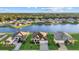 An aerial shot of single-Gathering homes backing up to a large pond with green grass and tree canopies at 15909 39Th E Gln, Parrish, FL 34219
