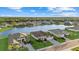 Aerial view of the back of homes on a lake, surrounded by green grass and tree canopies at 15909 39Th E Gln, Parrish, FL 34219