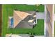 Aerial view of a home showcasing roof, pool, manicured lawn and paver driveway in an upscale neighborhood at 15909 39Th E Gln, Parrish, FL 34219