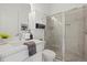 Bathroom with granite countertops, framed mirror, tiled shower with glass door, and updated cabinetry at 15909 39Th E Gln, Parrish, FL 34219
