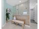 Bathroom features a glass shower, bench seat, and neutral colors at 15909 39Th E Gln, Parrish, FL 34219