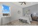 Bedroom with large window, accent wall, and neutral-colored furnishings at 15909 39Th E Gln, Parrish, FL 34219