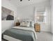Cozy bedroom with soft carpet, queen-size bed, side tables, lamps, and a decorative painting at 15909 39Th E Gln, Parrish, FL 34219