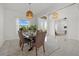 Dining room with a modern light fixture and seating for eight in an open concept floor plan at 15909 39Th E Gln, Parrish, FL 34219