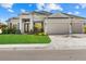 Beautiful home featuring a well-manicured lawn, paver driveway, and a spacious three-car garage at 15909 39Th E Gln, Parrish, FL 34219
