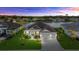 Beautiful single-Gathering home with a well manicured lawn, three car garage, and lake in the background at 15909 39Th E Gln, Parrish, FL 34219