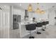 Kitchen boasts stainless steel appliances, white cabinets, marble countertop, and a view of the living space at 15909 39Th E Gln, Parrish, FL 34219