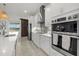Modern kitchen with white cabinets, stainless steel appliances, breakfast bar, and a view of the backyard at 15909 39Th E Gln, Parrish, FL 34219