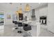 Kitchen boasts modern white cabinets, marble countertops, stainless steel appliances, and bar stool seating at 15909 39Th E Gln, Parrish, FL 34219