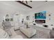 Open-concept living space with tile floors, modern decor, and a view into the dining area at 15909 39Th E Gln, Parrish, FL 34219