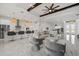 Spacious, open-concept living room flowing into the kitchen with barstool seating and modern lighting at 15909 39Th E Gln, Parrish, FL 34219