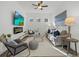 Living room with comfortable seating, fireplace, and ceiling fan at 15909 39Th E Gln, Parrish, FL 34219