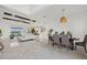 Open living space with modern decor including the living room, dining room and kitchen with white cabinets at 15909 39Th E Gln, Parrish, FL 34219