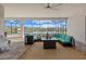 Screened patio with wicker furniture, ceiling fan, and beautiful views of the lake behind the house at 15909 39Th E Gln, Parrish, FL 34219