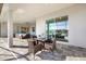 Beautiful patio with a table set and seating area overlooking the water with sliding glass doors to the inside of the home at 15909 39Th E Gln, Parrish, FL 34219