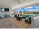 Spacious lanai with comfortable seating, outdoor TV, and stunning views of the lake and pool at 15909 39Th E Gln, Parrish, FL 34219