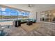 Screened-in patio with pavers, featuring comfortable seating and a view of the scenic lake at 15909 39Th E Gln, Parrish, FL 34219