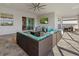 Inviting outdoor patio space with sectional sofa and a view of the tv, ceiling fan, and outdoor living area at 15909 39Th E Gln, Parrish, FL 34219