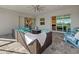 Covered outdoor patio with comfortable seating, ceiling fan, and lake view at 15909 39Th E Gln, Parrish, FL 34219