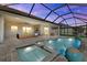 A gorgeous pool and hot tub area with pavers and a screened-in enclosure perfect for outdoor entertaining at 15909 39Th E Gln, Parrish, FL 34219