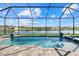 Relaxing screened-in pool with lake view, beautiful pavers, and multiple water features at 15909 39Th E Gln, Parrish, FL 34219
