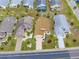 Aerial view of a well-manicured suburban home with a driveway and neatly landscaped front yard at 1603 E Del Webb Blvd, Sun City Center, FL 33573