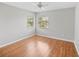Bedroom with wood floors featuring two windows providing natural light at 1603 E Del Webb Blvd, Sun City Center, FL 33573