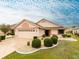 Charming single-story home with a well-manicured lawn, a two-car garage, and a beautifully patterned driveway at 1603 E Del Webb Blvd, Sun City Center, FL 33573