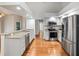 Modern kitchen featuring stainless steel appliances, granite countertops, and hardwood floors at 1603 E Del Webb Blvd, Sun City Center, FL 33573