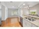 Bright kitchen featuring stainless steel appliances, granite countertops and a view of a seating area at 1603 E Del Webb Blvd, Sun City Center, FL 33573