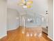 Open concept living room showcasing hardwood floors leading to a kitchen at 1603 E Del Webb Blvd, Sun City Center, FL 33573