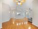 Open concept living room with hardwood floors with an adjacent kitchen at 1603 E Del Webb Blvd, Sun City Center, FL 33573