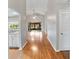 Open living space with hardwood floors leading to sliding doors, and view of the kitchen and outdoor seating at 1603 E Del Webb Blvd, Sun City Center, FL 33573