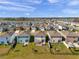 An aerial view of Gathering homes, featuring lush green lawns and beautifully landscaped yards at 16051 Soft Fern Trce, Odessa, FL 33556