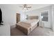 Bright bedroom featuring a large bed, and lots of natural light at 16051 Soft Fern Trce, Odessa, FL 33556