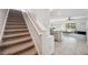 Carpeted staircase leading to an open floor plan featuring the kitchen and Gathering room at 16051 Soft Fern Trce, Odessa, FL 33556