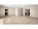 Bright living room with tile floors flowing into the kitchen area and a view of the home's entrance at 1629 Brook Dr, Dunedin, FL 34698