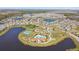 Aerial view of the community featuring lakes, parks, a pool, and tennis courts at 16614 Mosaic Oar Dr, Wimauma, FL 33598