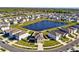 Aerial view of community with a lake surrounding well-maintained homes and landscaping at 16614 Mosaic Oar Dr, Wimauma, FL 33598