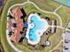 Aerial view of the community pool and amenity center, surrounded by lush landscaping at 16614 Mosaic Oar Dr, Wimauma, FL 33598