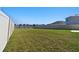 Generous backyard space enclosed by a white fence, offering privacy and room to roam at 16614 Mosaic Oar Dr, Wimauma, FL 33598