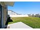 Expansive backyard features lush green grass and a white vinyl fence for privacy at 16614 Mosaic Oar Dr, Wimauma, FL 33598