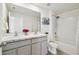 Bright bathroom featuring a double vanity with marble countertop, gray cabinets, and a shower/tub combination at 16614 Mosaic Oar Dr, Wimauma, FL 33598