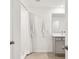 Bright bathroom featuring a shower with a curtain, and vanity with sink and mirror at 16614 Mosaic Oar Dr, Wimauma, FL 33598