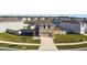 Stunning front exterior featuring manicured landscaping, a two-car garage, and a cozy front porch at 16614 Mosaic Oar Dr, Wimauma, FL 33598