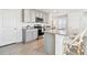 Stylish kitchen with granite countertops, stainless steel appliances, gray cabinets, and counter seating at 16614 Mosaic Oar Dr, Wimauma, FL 33598