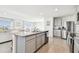 Open concept kitchen with granite countertops, stainless steel appliances, gray cabinets, and tile floors at 16614 Mosaic Oar Dr, Wimauma, FL 33598